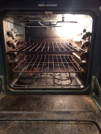 A reviewer's dirty oven with baked-on residue
