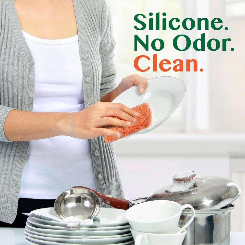 A model using the sponge, with the text &quot;silicone. no odor. clean&quot;