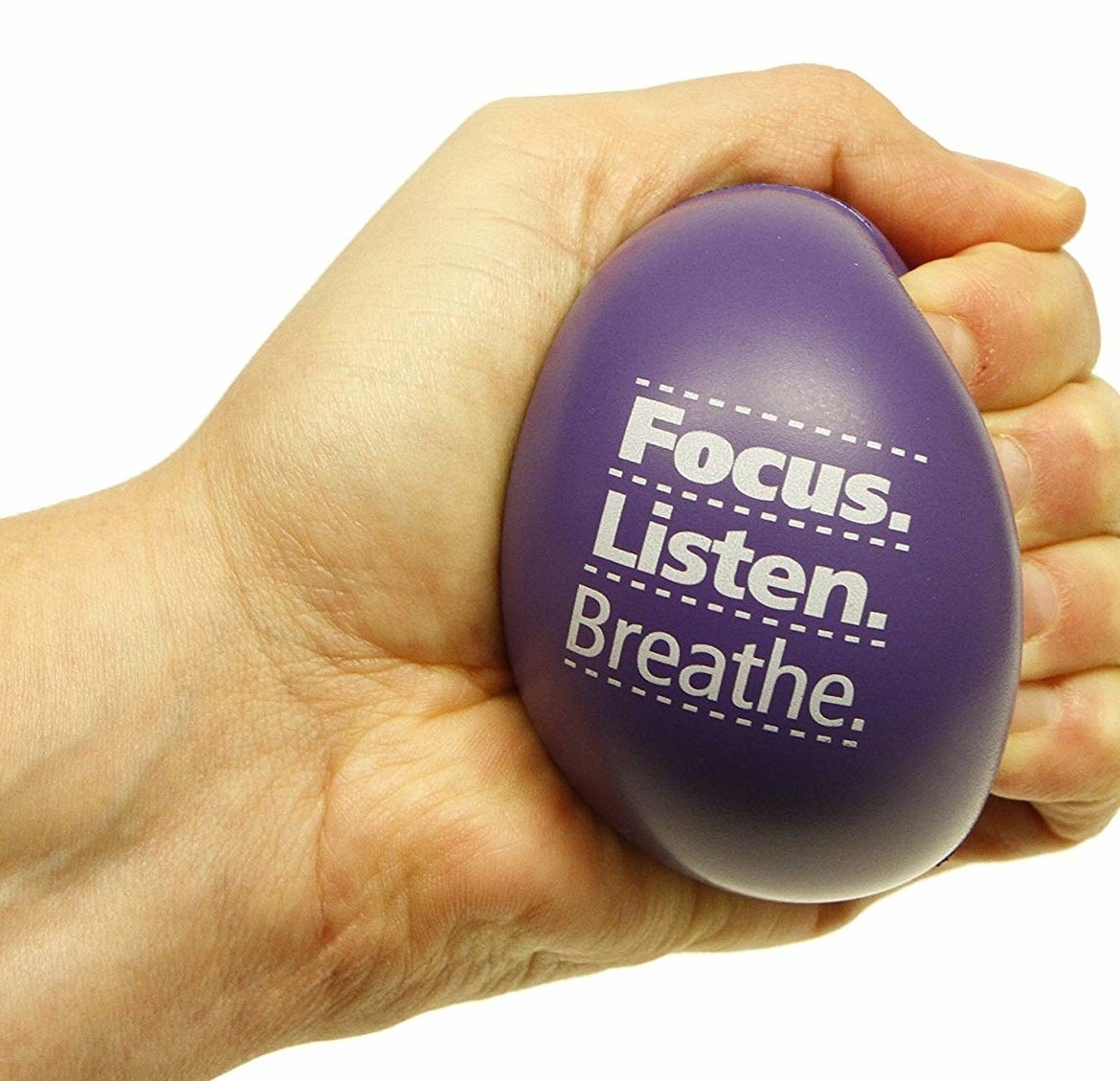 Model squeezing stress ball with the words &quot;focus, listen, breathe&quot;