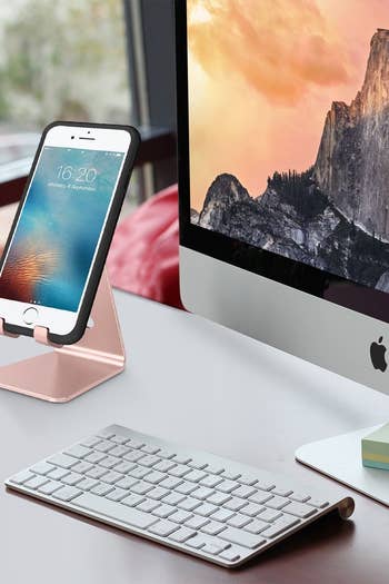 Phone stand placed on desk with iPhone sitting on top