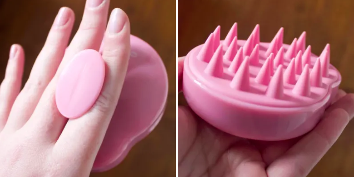 Reviewer photo of hand holding the massage brush showing the soft silicone bristles 