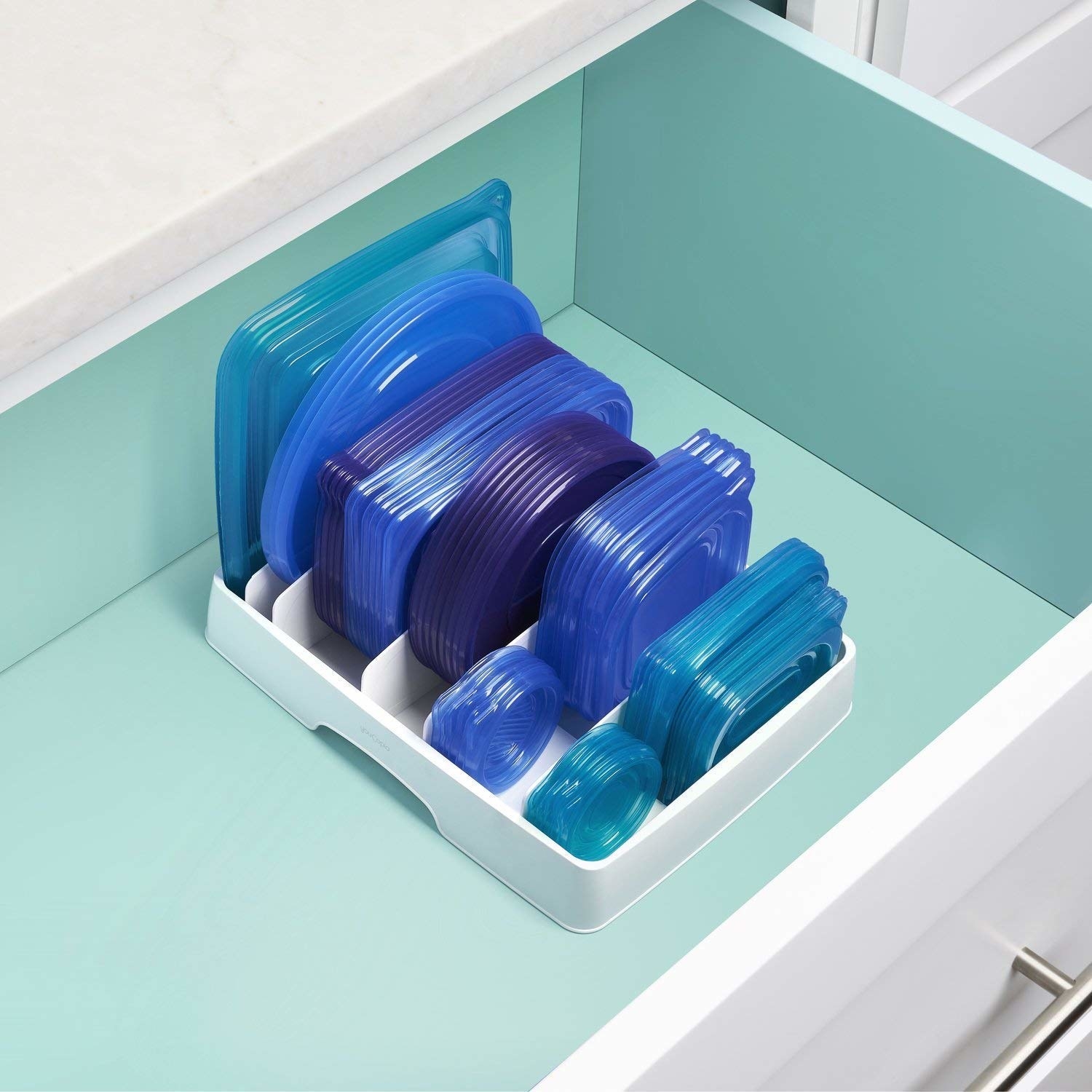 The organizer in a drawer holding six sizes of container lids