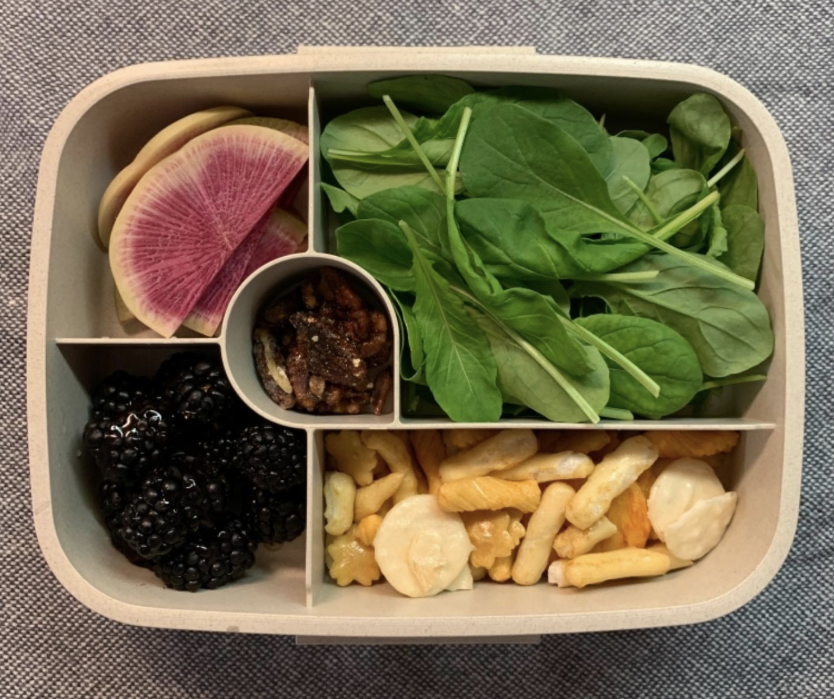 A reviewer photo showing a top-down view of the bento box filled with different food in each compartment 