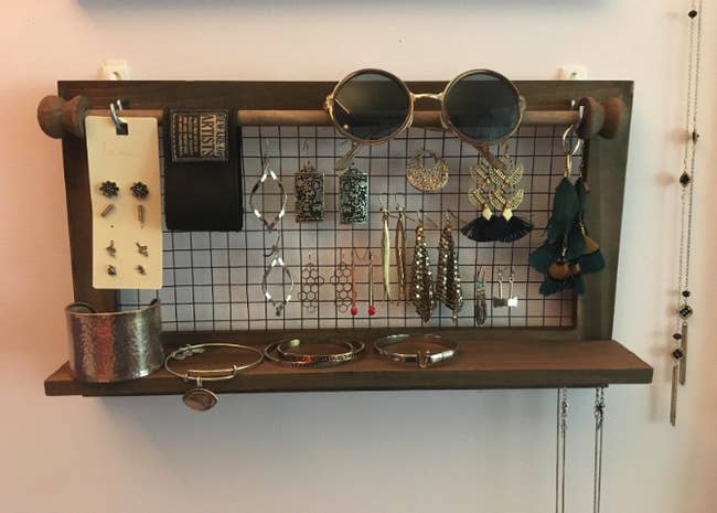 wood and wire shelf holding reviewer's earrings and other accessories 