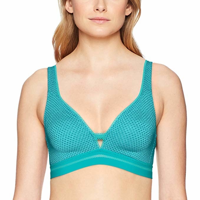 Model, which has a small triangle cutout,  wearing the bra in teal