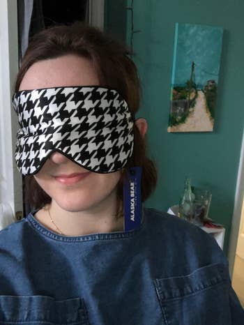 reviewer wearing the oversized eye mask in houndstooth print