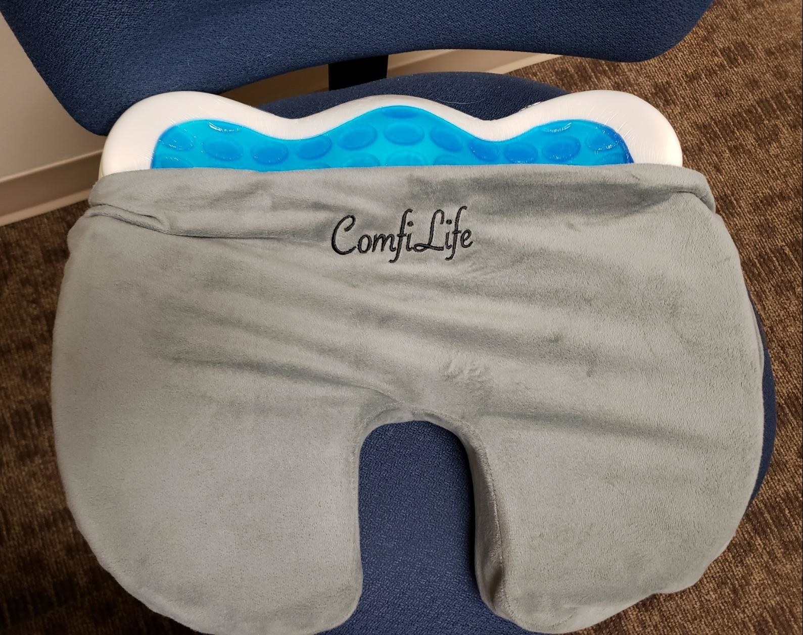 A reviewer&#x27;s memory foam cushion with the case unzipped and partially removed to reveal the cooling gel underneath