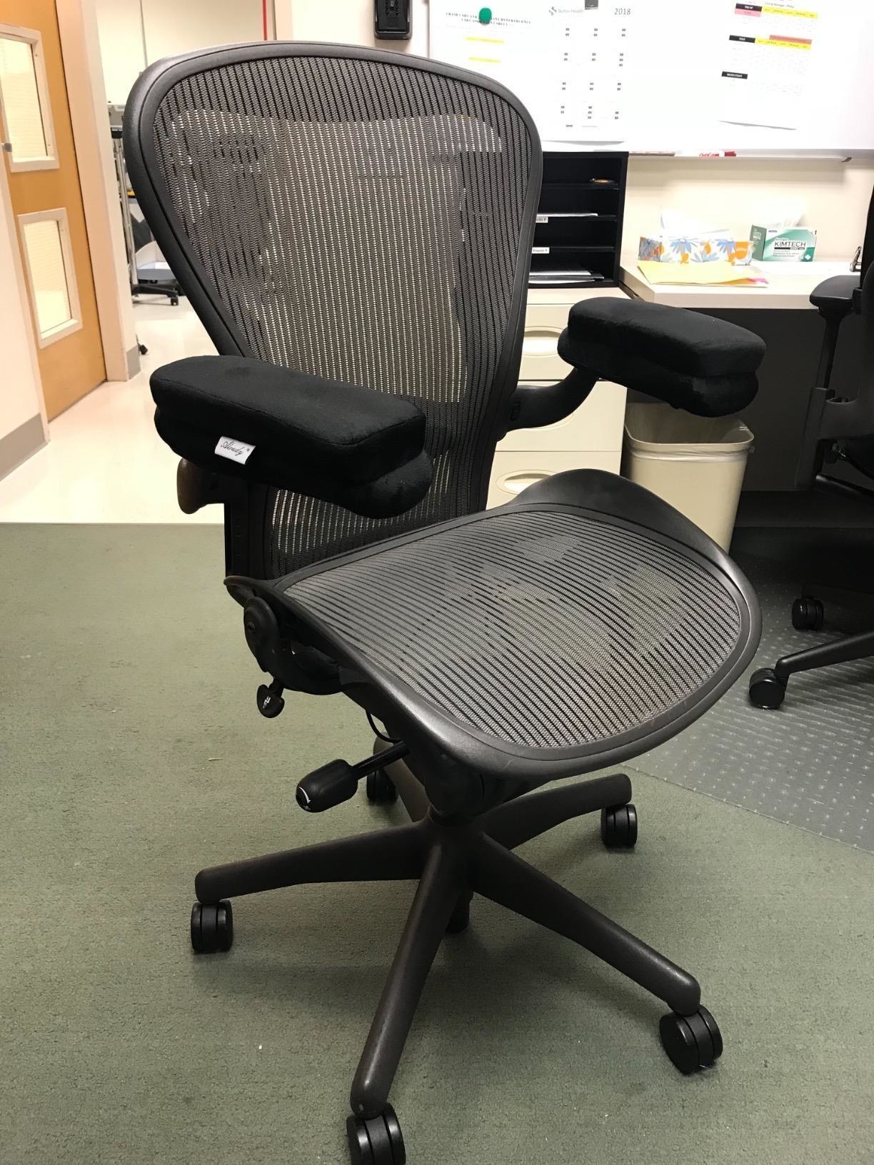 A reviewer&#x27;s office chair with the armrest toppers attached to each arm rest