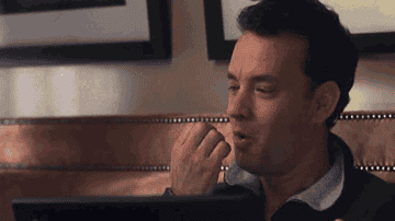 Gif of Tom Hanks blowing on his fingers before getting ready to type