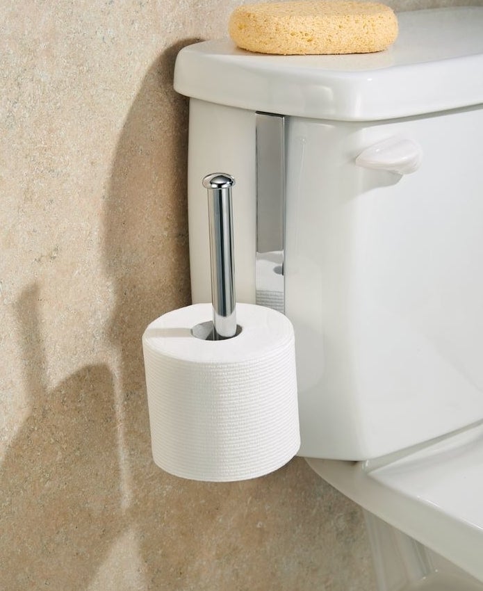 silver toilet paper holder on toilet