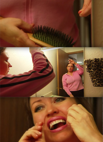 A woman using a strand of her hair to floss