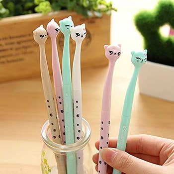 Pens with cat faces at the end in different pastel colors