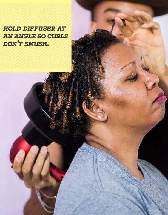 model getting her hair styled with a diffuser with the text &quot;hold diffuser at an angle so curls don&#x27;t smush&quot; overlaid