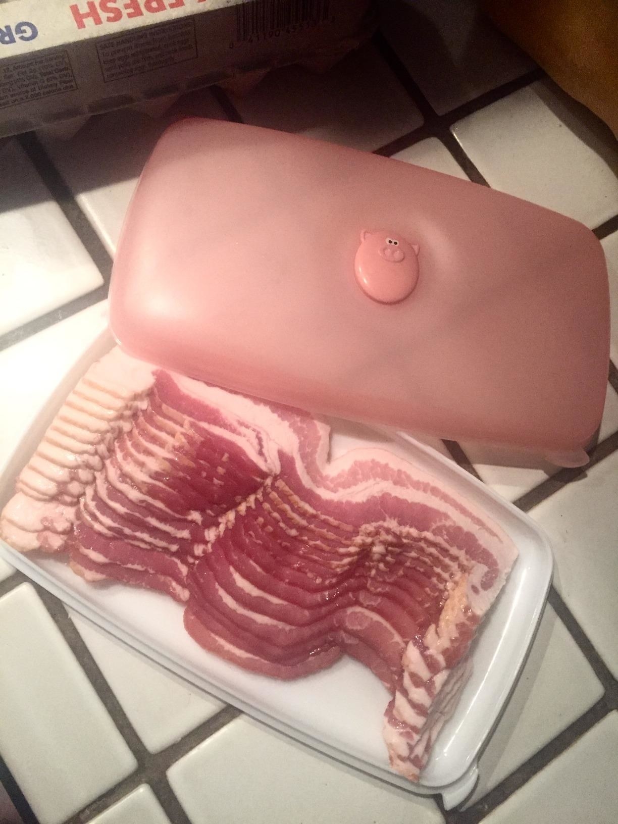Reviewer photo of the bacon holder with whole package of bacon in it