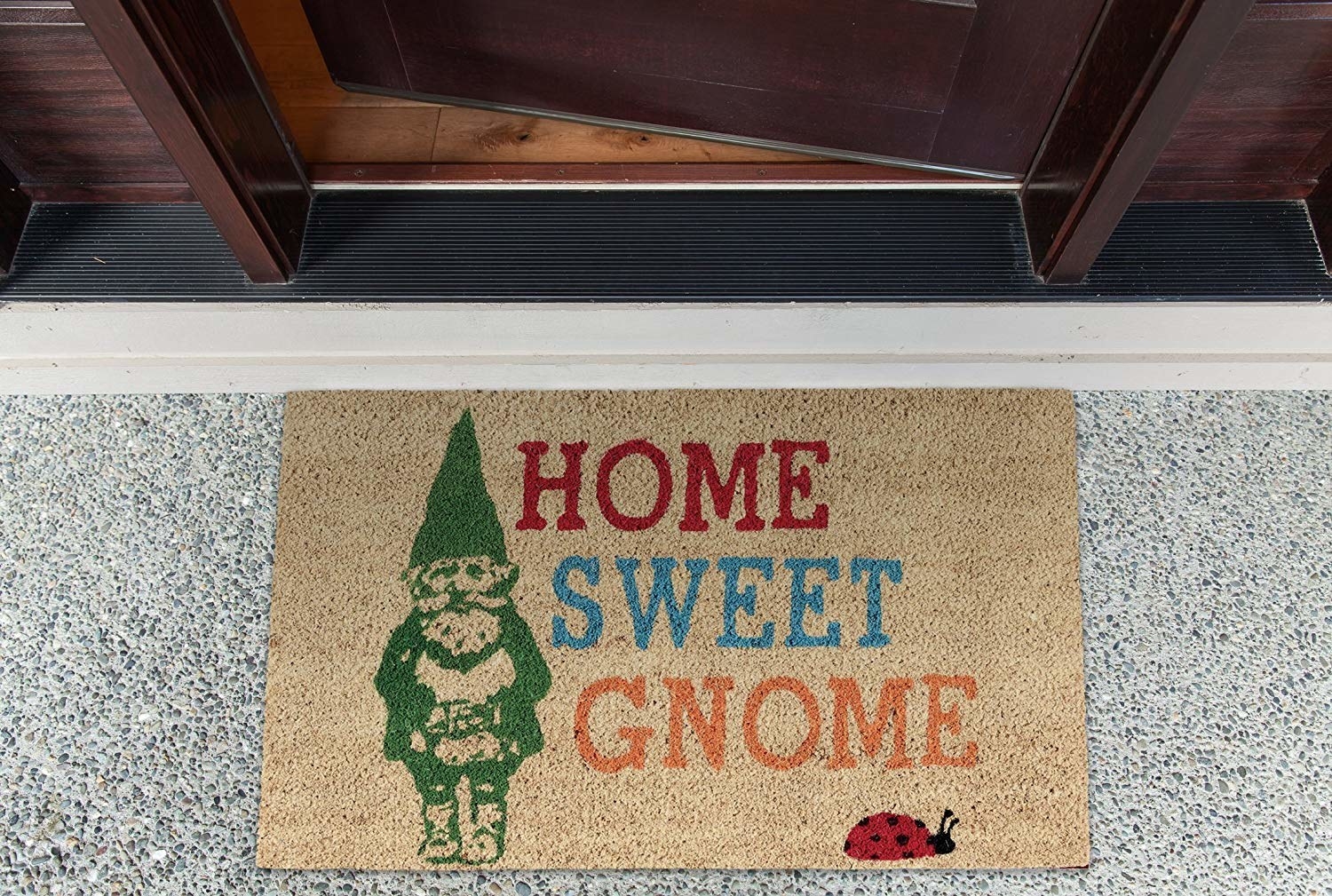 a welcome mat that says home sweet gnome and has a gnome and ladybug