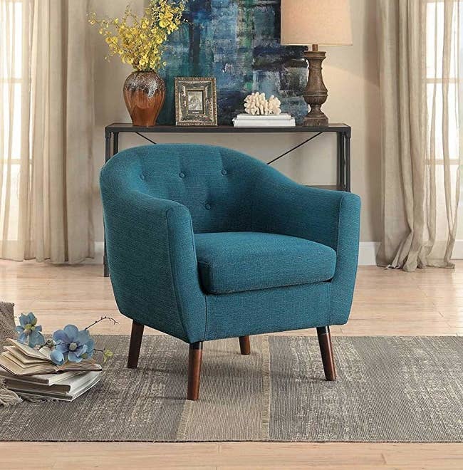 plush blue chair with wooden legs 