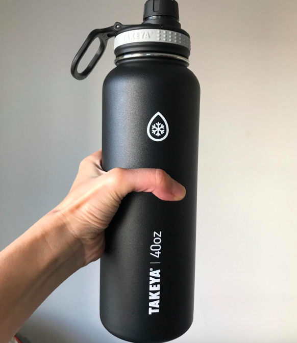 reviewer picture of hand holding black water bottle 