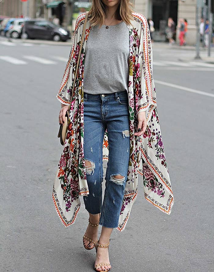 model wears long button-less cardigan with floral design