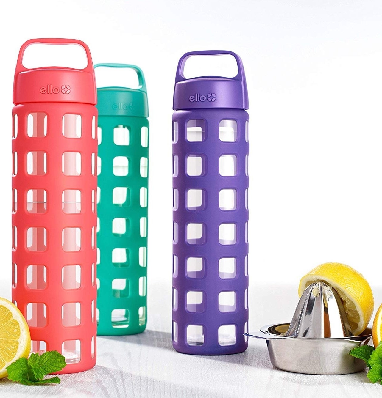 the clear bottles with silicone cover in pink, green, and purple 