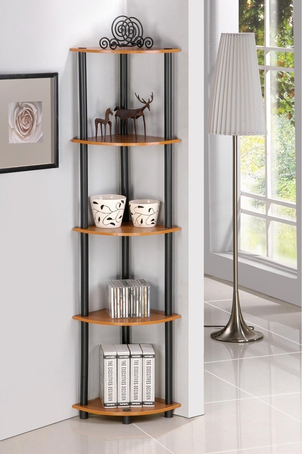 The shelf with five brown shelves and black tubes connecting them in the corner of the room with trinkets on it