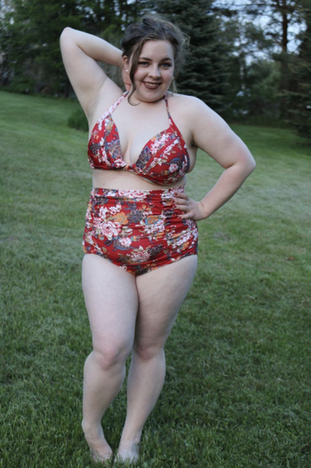 reviewer wearing bathing suit on grass