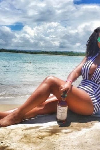 Reviewer is wearing the white and black striped suit with a plunging neckline