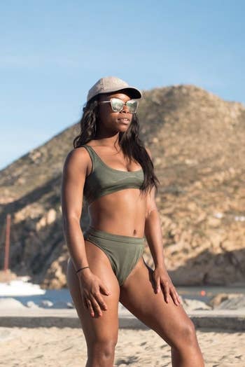reviewer wearing the high-waisted swimsuit and bikini top in olive green