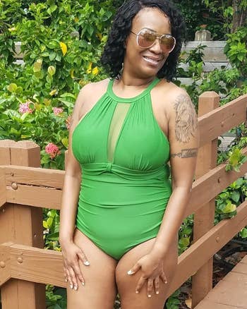 Reviewer is wearing the high neck bathing suit with a mesh cutout on the bust area in a lime green color
