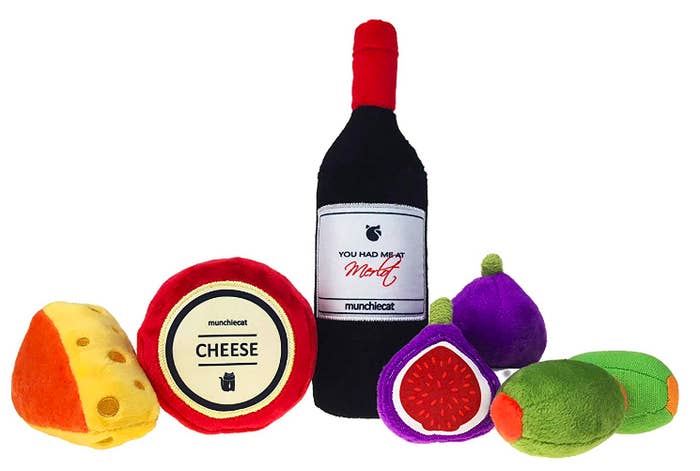 Plush wine bottle, two cheeses, two figs, and two olives 