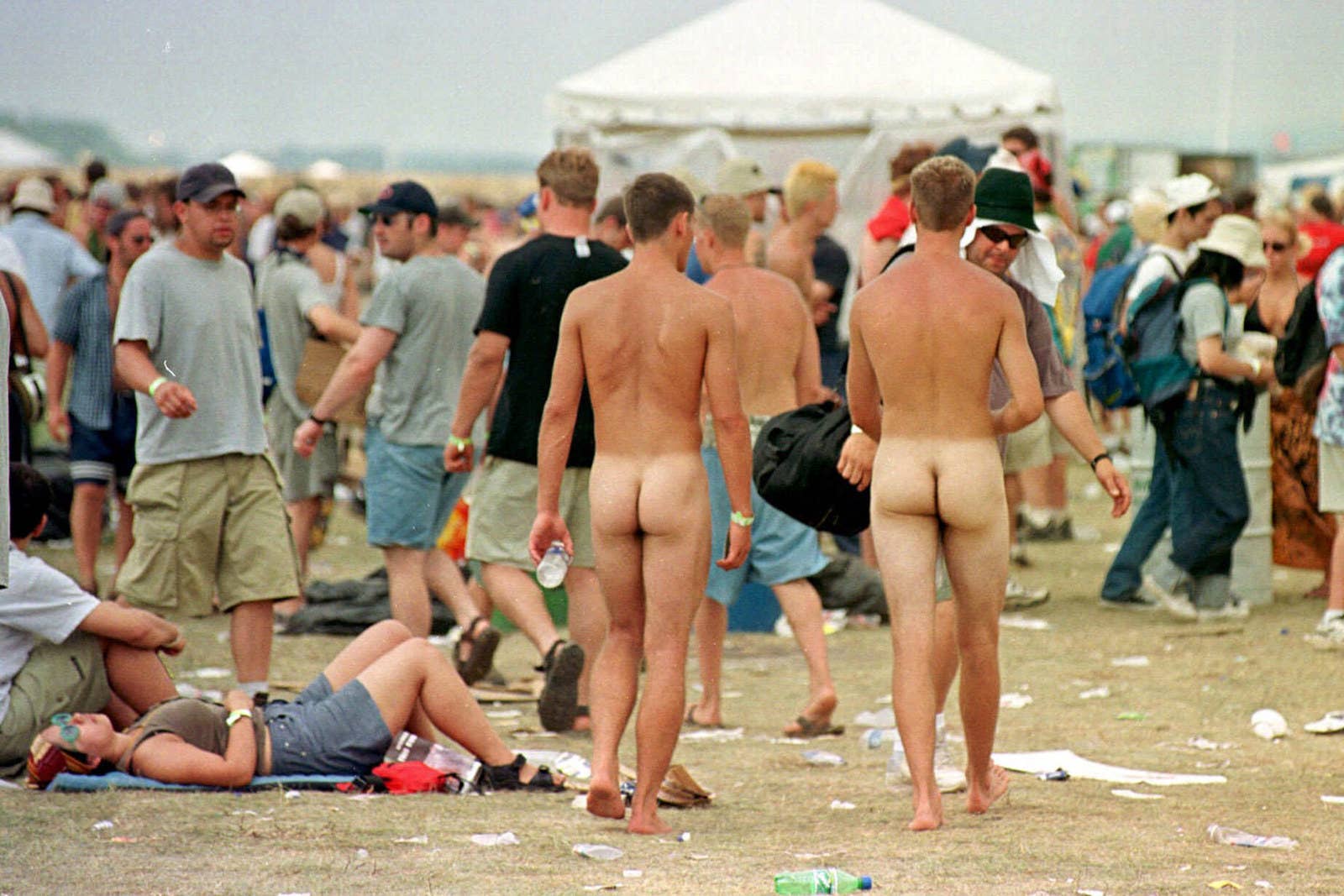 Two naked men stroll through the grounds of Woodstock '99 on July 24. 