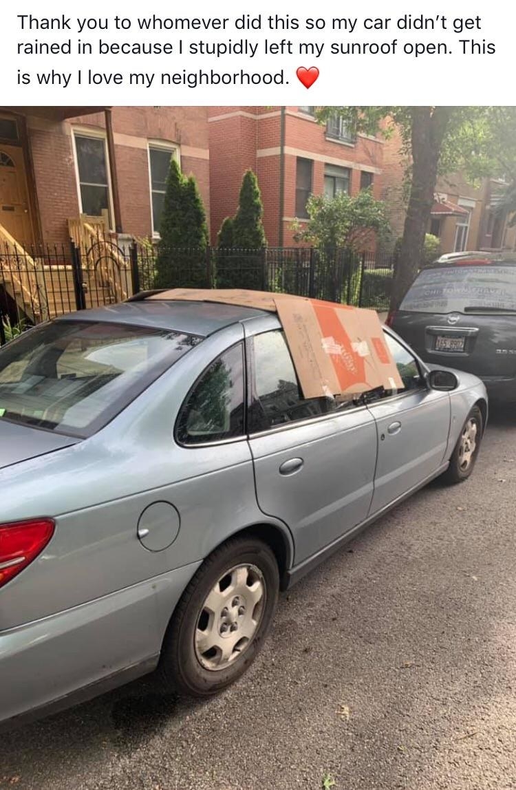 cardboard placed over an open sunroof to avoid rain