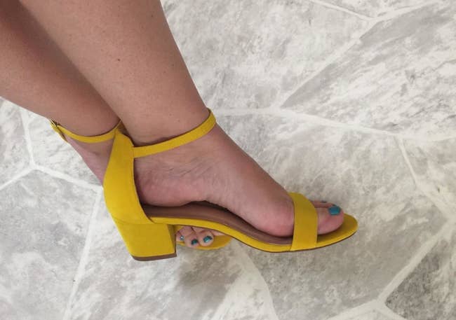 reviewer wearing the heels in yellow