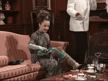 Amanda Bynes on The Amanda Show dressed to the nines and scratching a very hairy leg with a motorized brush