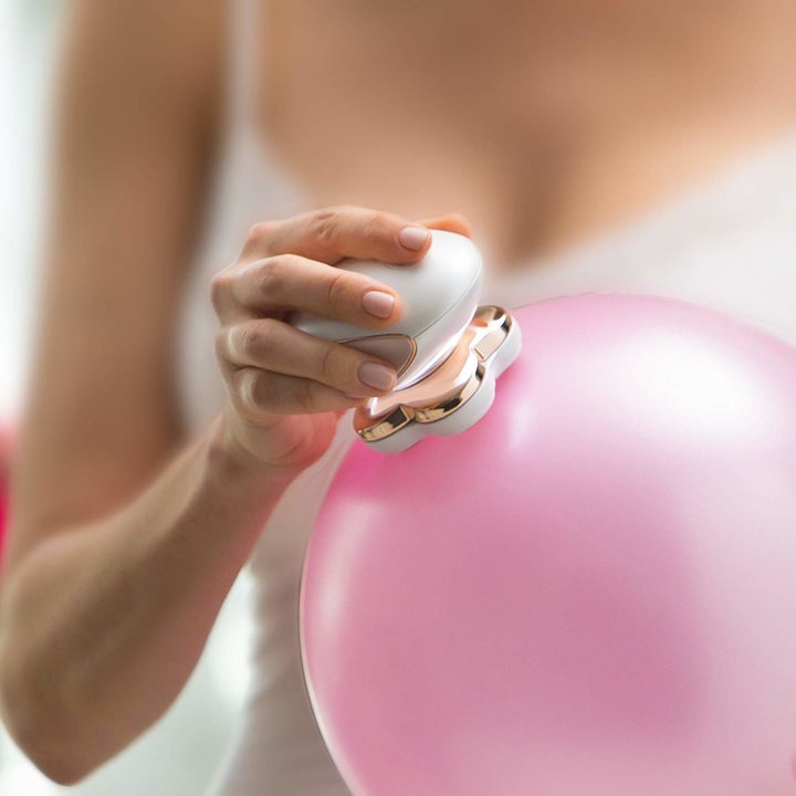 Model running the razor over a balloon, showing how gentle it is on skin
