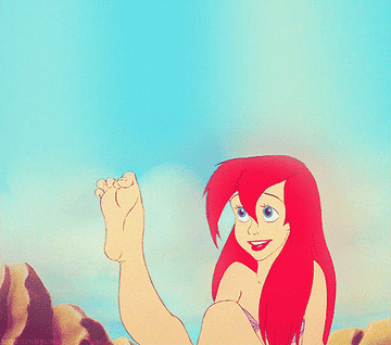 a gif of ariel from the little mermaid looking at her new foot and wiggling her toes