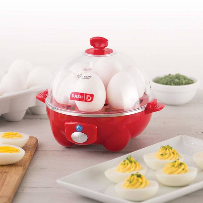 egg cooker filled with eggs and deviled eggs around it
