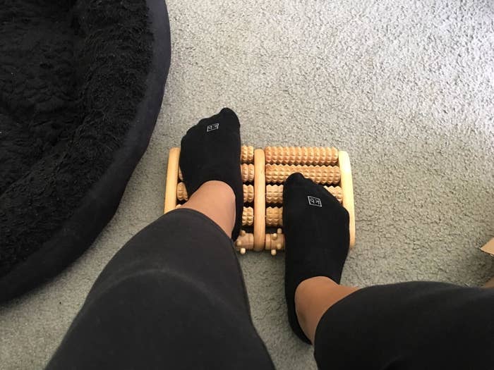 Reviewer&#x27;s socked feed on the textured wood roller