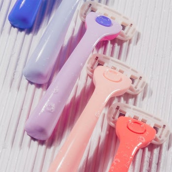 razors with pastel plastic handles lined up 