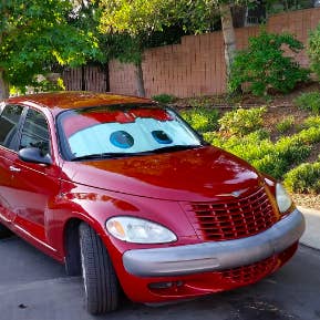 Reviewer photo of a red car with matching eyeball sunshade 