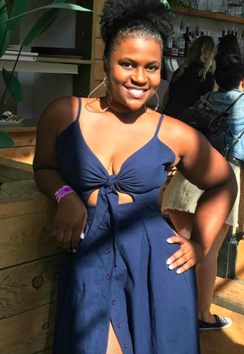 reviewer wearing the navy dress