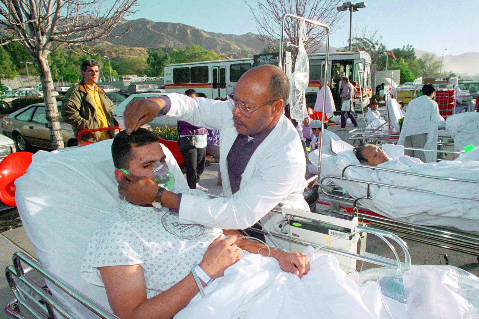Doug Pizac / AP A man is treated for injuries at an emergency unit set up in the Sylmar neighborhood of Los Angeles, Jan. 17.