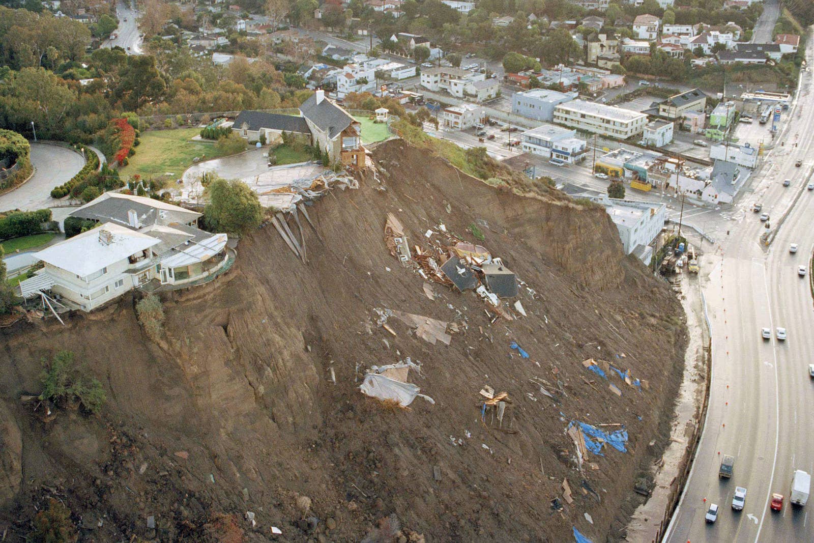 Mark J. Terrill / AP One home and the remains of another sit precariously on a cliff above the Pacific Coast Highway on Feb. 8.