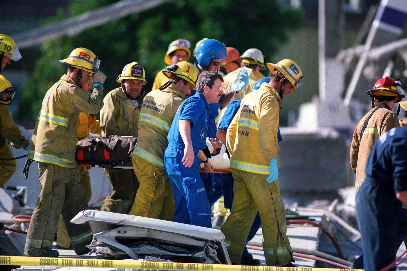 Afp / AFP / Getty Images Emergency personnel carry a janitorial worker who was rescued from a collapsed garage at the Northridge Mall on Jan. 17.