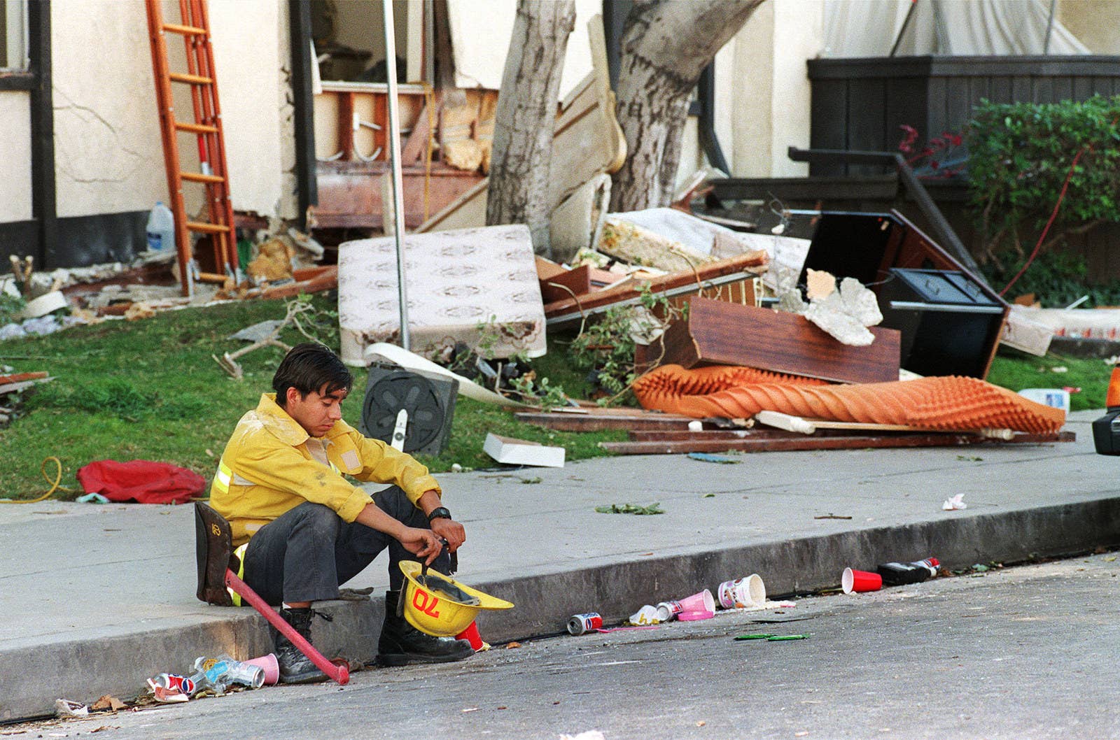 Chris Wilkins / AFP / Getty Images A rescue worker sits in front of the heavily damaged Northridge Meadows Apartments on Jan. 17.