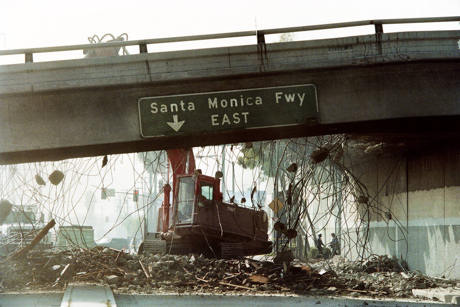 Timothy A. Clary / AFP / Getty Images A bulldozer tears down a section of the Santa Monica Freeway that collapsed during the Northridge earthquake, on Jan 19.