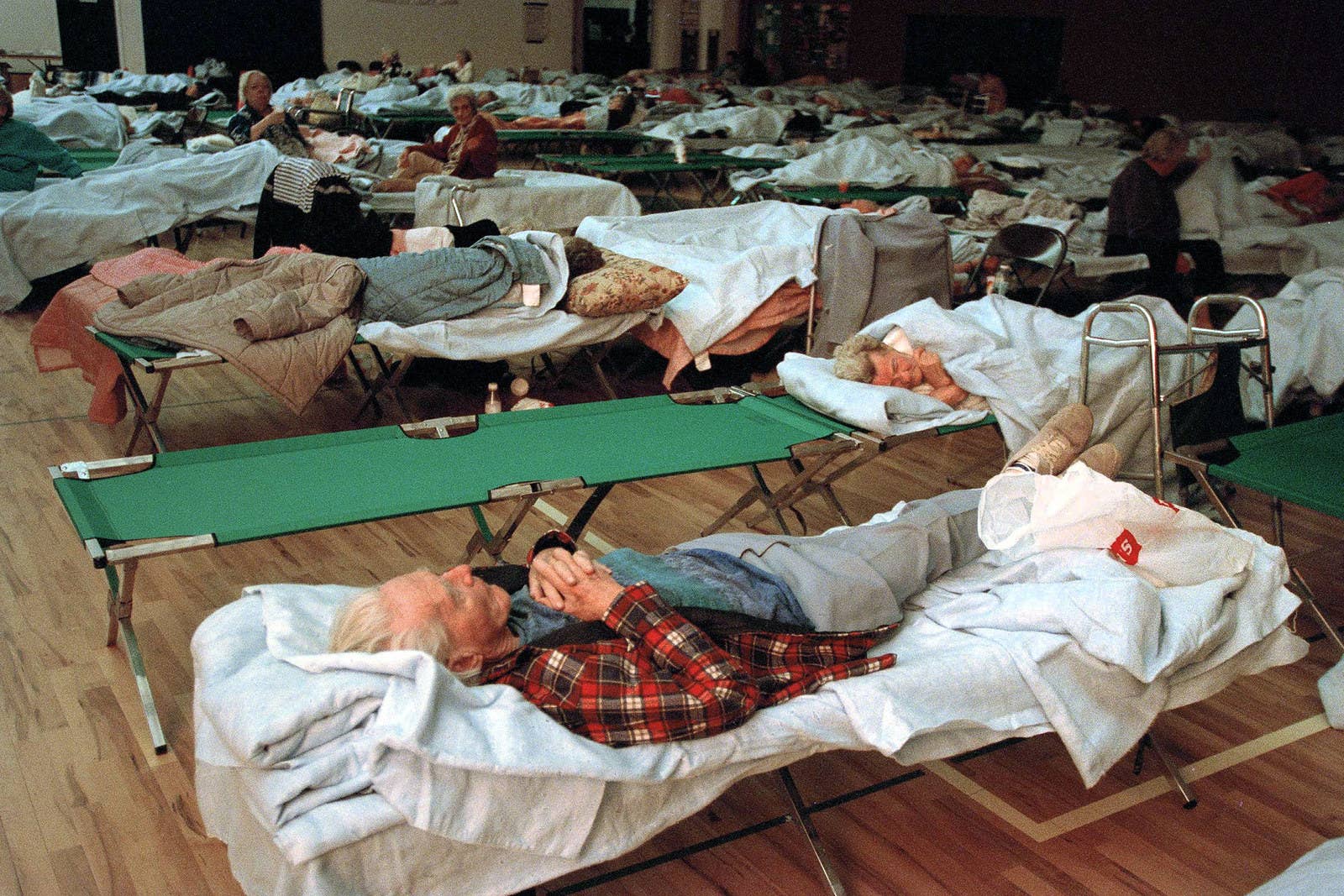 Rick Bowmer / AP A man sleeps at a Red Cross shelter set up in the Santa Clarita Boys and Girls Club on Jan. 18.