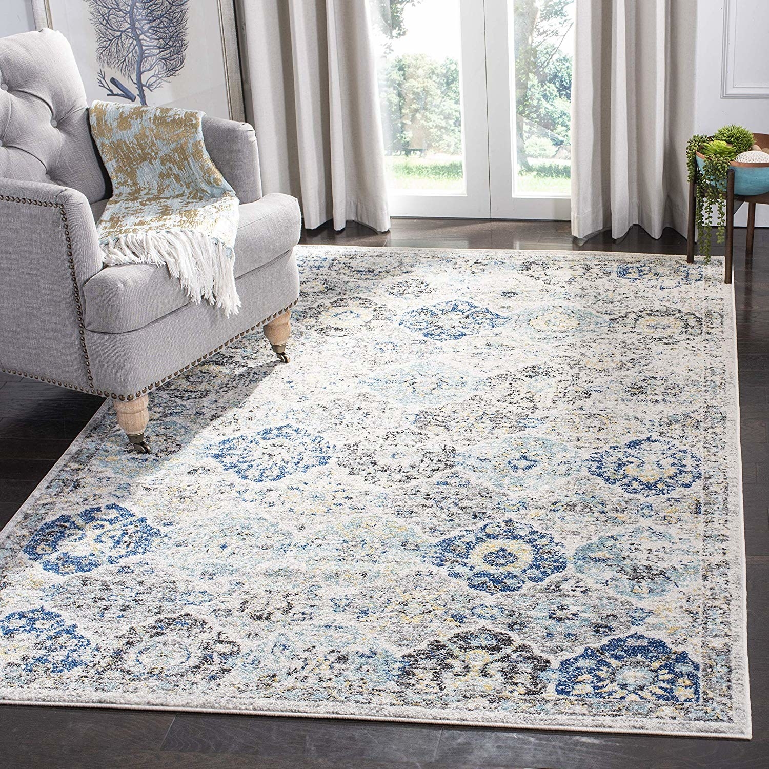 a white rug with blue and gray designs on it