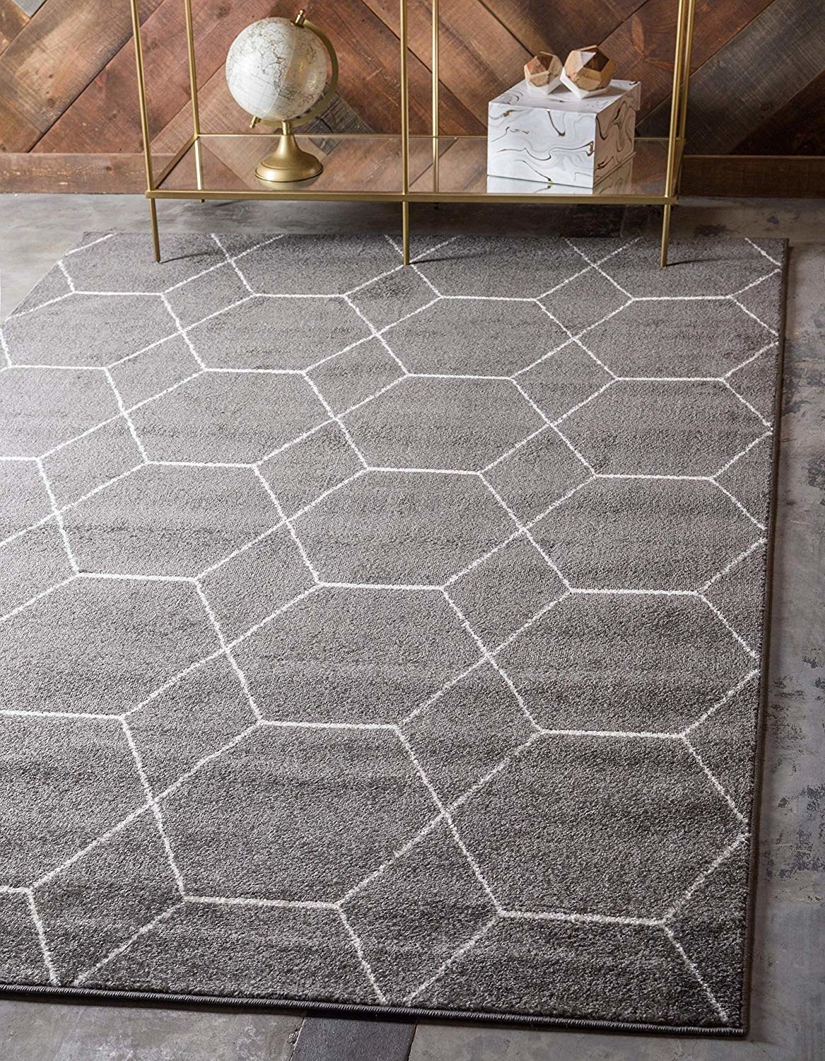 a gray rug with a white hexagon pattern across it 