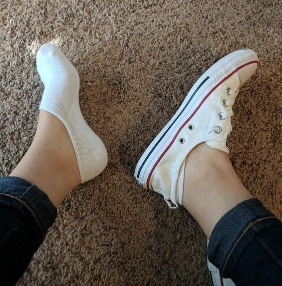 a pair of feet wearing the no-show socks with a sneaker on the right foot