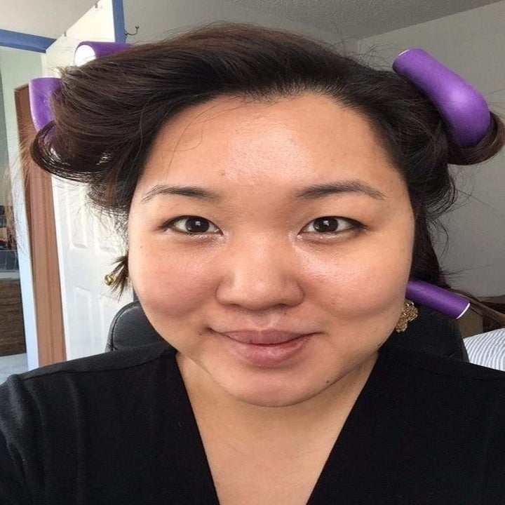 a reviewer with the curling rods in their hair